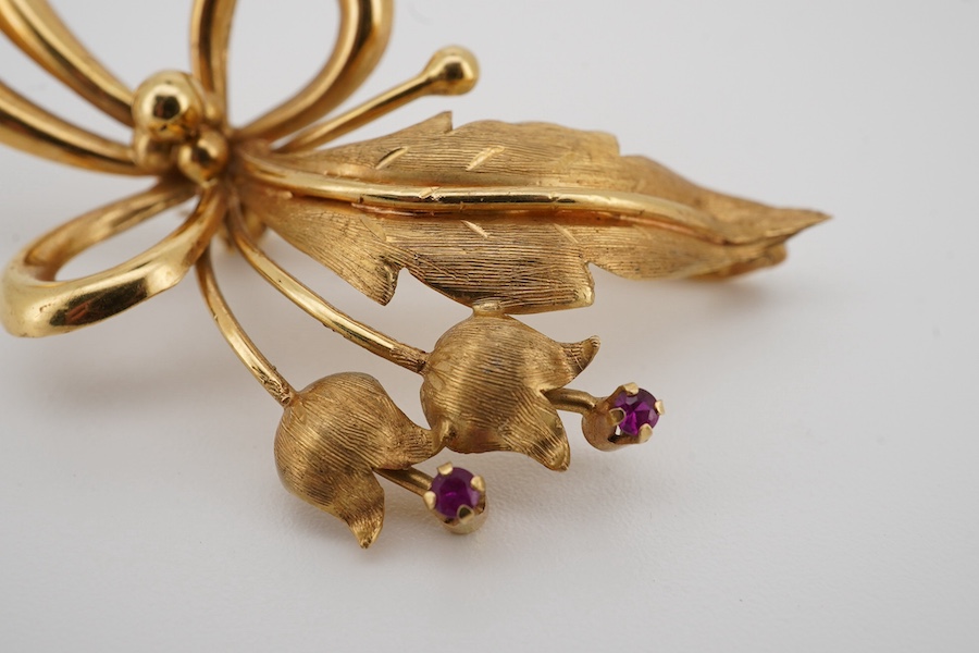 A modern 18k and two stone ruby set foliate spray brooch, 50mm, gross weight 6.7 grams. Condition - fair to good